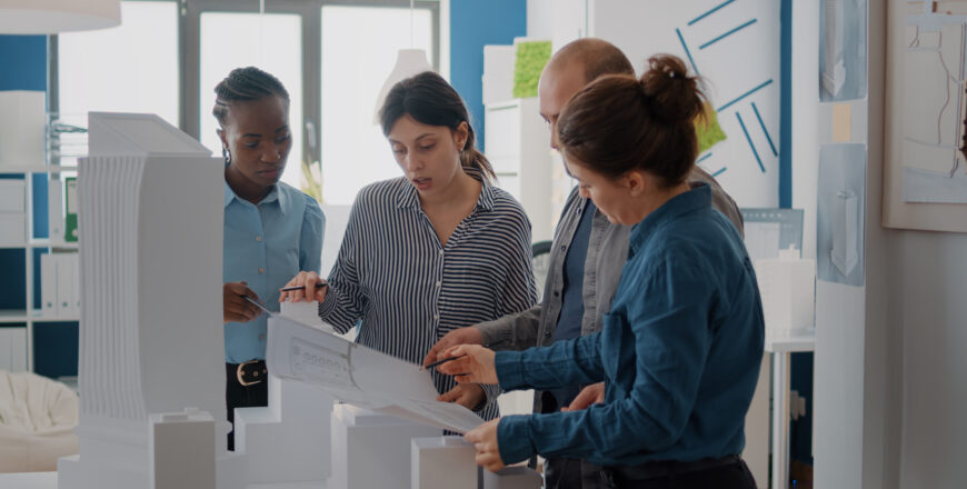 diverse-group-colleagues-working-building-model-design-with-blueprints-plan-coworkers-using-maquette-industrial-sketch-create-architecture-project-brainstorming-ideas.jpg